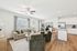 Inviting open-concept living room with modern decor and a chic kitchen island, featuring warm wooden floors and abundant natural light.