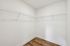Spacious modern closet with white wire shelving and elegant wood flooring, perfect for maximizing storage.