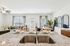 Modern open-concept living area with stylish granite countertop, cozy seating, and chic decor. Perfect for relaxation and entertaining.