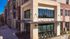 Modern apartment complex exterior featuring stylish brick and stone facade with spacious windows and inviting entryway.