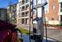 Modern apartment complex offering convenient on-site electric vehicle charging station under sunny blue skies.