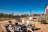 Idyllic outdoor living space with modern fire pit, cozy seating, and string lights, perfect for relaxation and entertaining.