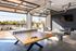 Chic recreational area with ping-pong table, cozy seating, and open-air design perfect for leisure and entertainment.