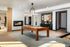 Elegant apartment game room featuring a modern pool table, cozy fireplace, and stylish decor with ample natural light.