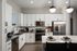 Modern kitchen with sleek white cabinetry, stainless steel appliances, and a polished island breakfast bar for stylish living.