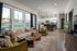Chic apartment living room with a cozy sofa, stylish chairs, and a modern open-concept kitchen.