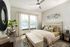Bright and inviting bedroom featuring modern decor, a plush bed, and ample natural light from large windows.