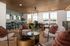 Elegant open-concept living area with stylish decor, featuring plush seating, modern dining space, and large windows for natural light.