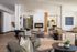 Elegant living room with contemporary decor, featuring a cozy fireplace, stylish furniture, and warm lighting, perfect for relaxation.