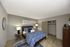 Cozy modern bedroom with stylish decor, featuring a plush bed, elegant lighting, and a spacious closet.