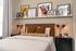 Inviting bedroom with chic wall art, cozy bedding, and elegant lighting; an ideal tranquil retreat.
