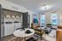 Modern apartment interior with stylish living area and in-unit laundry facilities, featuring cozy seating and a dining area for ultimate comfort and convenience.