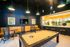 Contemporary lounge with a stylish billiards table, ambient lighting, and cozy seating, perfect for relaxation and entertainment.
