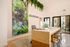 Chic and modern reception area featuring a stylish reception desk, vibrant wall art, and elegant greenery accents at Silversaw.