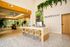 Bright and welcoming modern office space featuring a stylish reception desk, lush greenery, and expansive windows with natural light.