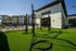Modern apartment complex with vibrant outdoor fitness area and lush greenery, ideal for active lifestyles.