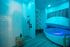 Luxurious spa-like bathroom with a cutting-edge floating pod, elegant rain shower, and modern decor illuminated by soothing ambient lighting.