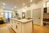 Inviting open-plan apartment with modern kitchen island, cozy living area, and abundant natural light.
