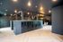 Modern apartment lobby with sleek mailbox area, elegant lighting, and stylish seating, offering a welcoming ambience.