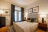 Cozy bedroom with elegant decor, featuring a plush bed, stylish nightstands, and soft lighting for a serene ambiance.