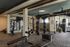 Modern fitness center with state-of-the-art gym equipment including weights, TRX bands, and a punching bag, set in a stylish, spacious environment.