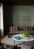 Chic living room with cozy brown chairs and a stylish marble coffee table adorned with greenery, set against a serene wall art backdrop.