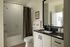 Modern bathroom with sleek black and white decor, featuring a bathtub, elegant sink, and stylish accessories.