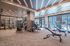 Modern and spacious fitness center with state-of-the-art gym equipment and stylish lighting design.