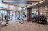 State-of-the-art fitness center with modern treadmills, weight benches, and a full set of dumbbells in a stylish, well-lit space.