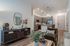 Modern apartment interior showcasing a cozy living area with stylish decor, open kitchen with pendant lighting, and elegant furnishings.