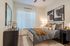 Modern and cozy bedroom with elegant decor, plush bedding, and large abstract artwork, offering a peaceful retreat.