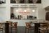 Modern coffee bar with elegant wooden tables and chic lighting, featuring Trapeze Coffee's sleek design and cozy seating.