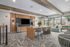 furnished clubroom area with television, table and seating