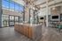 furnished clubroom with kitchen island and high ceilings