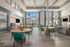 furnished clubroom with kitchen, seating and tables