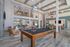 furnished clubroom with billiards table, seating and tables