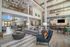 furnsihed clubroom with seatings, tables, and high ceilings and windows