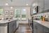 Birmingham, AL Luxury Apartments - Tributary Rise - Culinary-Style Kitchen With Stainless Steel Appliances, Built-In Microwave, Granite Countertops, Island, Oversized Sink, And Hardwood-Style Flooring.