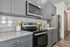 furnished kitchen with microwave and stove in apartment home