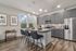 Birmingham, AL, Apartments - Tributary Rise - Culinary-Inspired Kitchen with Hardwood-Style Flooring, Granite Countertops, Breakfast Bar with Bar-Style Chairs, Whirlpool Appliances, Windows with Blinds, and Pendant Lighting.