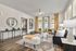 Studio Apartments in Birmingham, AL - Tributary Rise - Living Room With Hardwood-Style Flooring, Area Rug, Couch, End Tables With Lamps, Armchairs, Bench, Coffee Table, Ceiling Fan With Light, Display Shelf, Round Mirror, Windows With Blinds, And Glass Door With Access To Patio.