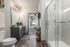 Birmingham Luxury Apartments - Tributary Rise - Bathroom With Large Vanity Mirror, Designer Lighting, And Walk-In Glass-Encased Shower.