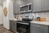 furnished kitchen with stove, oven and microwave in apartment home