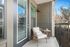 furnished patio area with armchair on sunny day