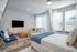 Furnished studio with bed and living room furniture