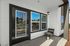 Charming outdoor patio area with modern black-framed glass door and cozy seating.
