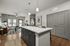 Modern open-concept living space with elegant kitchen island, cozy seating area, and ample natural light.