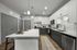 Modern kitchen with sleek countertops, stainless steel appliances, and elegant pendant lighting for a stylish cooking space.