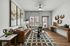 Chic living room showcasing a stylish leather sofa, artistic wall decor, and elegant furnishings, perfect for modern comfort.