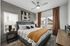 Bright and modern bedroom with plush bedding, contemporary art, and elegant decor, perfect for relaxation.